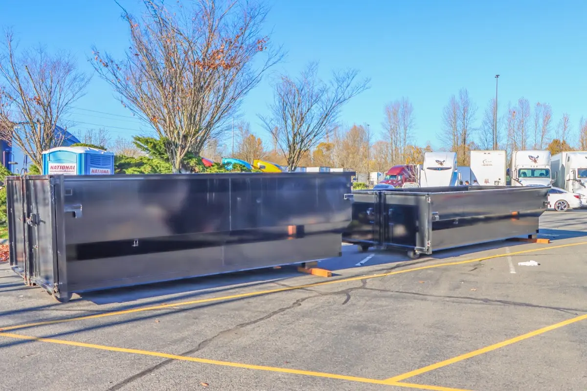 Professional dumpster rental service with roll-off container on residential driveway in Port Angeles